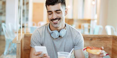 Young couple messaging back and forth on their mobile devices